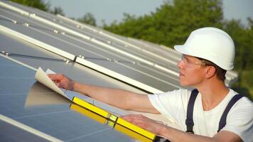 Solar panel technician working with solar panels. The green energy concept video