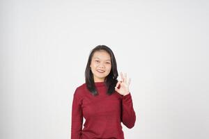 Young Asian woman in Red t-shirt smiling and showing okay sign isolated on white background photo