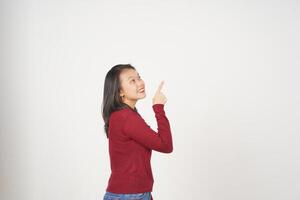 Young Asian woman in Red t-shirt Pointing up at copy space isolated on white background photo