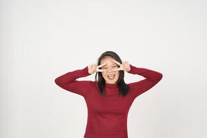 Young Asian woman in Red t-shirt smiling and showing peace or victory sign showing  isolated on white background photo
