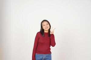 Young Asian woman in Red t-shirt smiling and showing peace or victory sign showing  isolated on white background photo