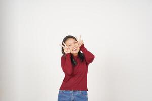 Young Asian woman in Red t-shirt smiling and showing peace or victory sign showing  isolated on white background photo