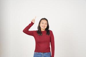 Young Asian woman in Red t-shirt Pointing up at copy space isolated on white background photo