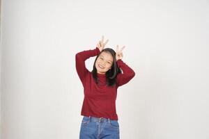 Young Asian woman in Red t-shirt smiling and showing peace or victory sign showing  isolated on white background photo