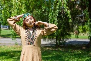 Armenian young woman in traditional clothes in the nature in summer photo