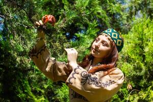 Armenian young woman in traditional clothes in the nature in summer photo