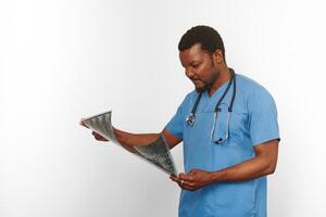 Black surgeon doctor bearded man in blue coat with crossed arms isolated white background copy space photo