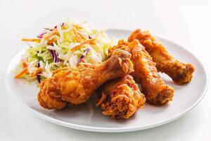 AI generated Fried chicken with coleslaw and salad on a white background photo