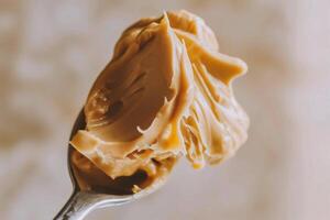 AI generated Creamy peanut butter on a spoon, close-up. photo