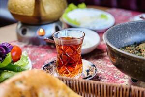 Table With Plates of Food and Cup of Tea photo