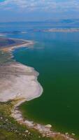Mono Lake in Mono County, California. Amazing scenery of calm waters of diverse colors from aerial perspective. Vertical video