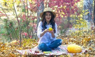 young woman in the garden in autumn photo