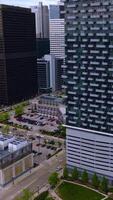 Multi- storied building with different balconies and parking lot beside. Drone footage rising to the top of the beautiful house. Vertical video