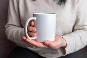 Woman's hands hold a pristine white mug, providing a perfect canvas for promoting mug designs photo