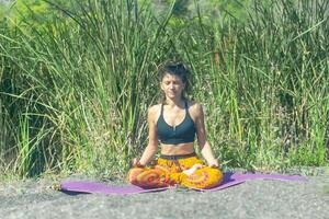 perrson doing yoga exercise on the beach, person relaxing on the beach, personn doing yoga photo