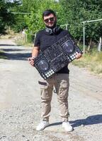 DJ con auriculares y mezclador en el parque, el DJ a trabajo foto