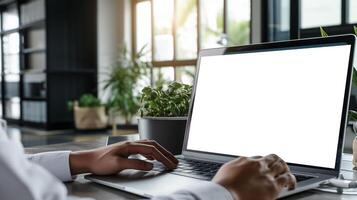 ai generado terminado hombro Disparo de un joven hombre utilizando computadora ordenador portátil en frente de un blanco blanco computadora pantalla en oficina foto