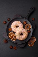 Delicious sweet bright donuts with cream on a plain background photo