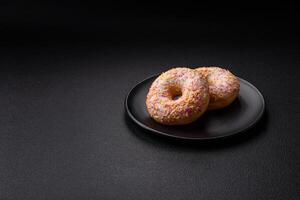 Delicious sweet bright donuts with cream on a plain background photo