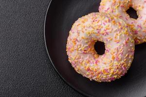 Delicious sweet bright donuts with cream on a plain background photo