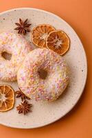 Delicious sweet bright donuts with cream on a plain background photo