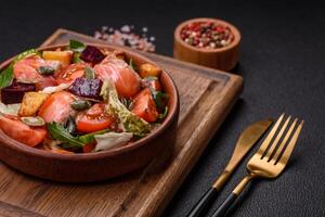 Delicious juicy salad with salmon, tomatoes, cucumber, herbs, pumpkin seeds photo
