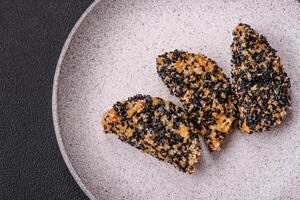 Delicious fresh crispy chicken or fish nuggets on a dark concrete background photo