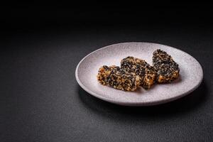 Delicious fresh crispy chicken or fish nuggets on a dark concrete background photo