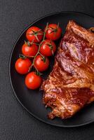 Delicious smoked or grilled ribs with olives, spices and herbs photo