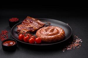 Delicious grilled sausage in the form of a ring with salt, spices and herbs photo