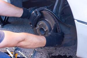 mechanic changing car wheel, car mechanic changing the wheel of a car photo