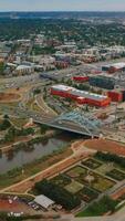 Roads, crossroads, bridges of beautiful Denver, Colorado, USA. South Platte River going parallel to busy highways. Green city panorama at backdrop. Vertical video