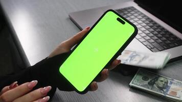 Person holding chroma key green screen smartphone watching content. Money concept. Department store. Mall. Shopping online. Gadgets and contemporary people concept video