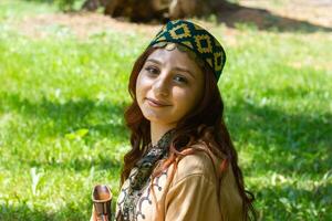 Armenian young woman in traditional clothes in the nature in summer photo