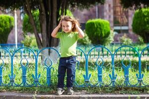 happy little boy playing in the park, long hair boy in the park photo