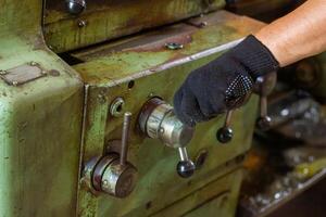 close up of a man using a machine, close up of a man working on a machine photo