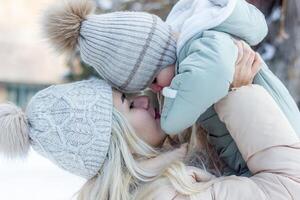 mother and baby boy in winter, parent and child in winter photo