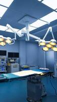 Large operational theatre with advanced equipment for modern surgeries. Leaving the operational room through the doorway leading to a dark hall. Vertical video