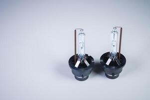 Xenon is a new two lamp for automotive headlights on a gray gradient background. Gas-discharge lighting devices photo