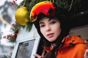 Portrait of a woman in the Alps. Young beautiful caucasian woman in ski goggles looking at the camera with a sexy look photo