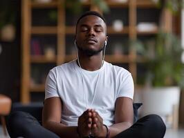 AI Generated A focused young man in a white shirt meditates indoors with his eyes closed and headphones on. Copy space photo