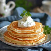 AI Generated A tall stack of pancakes topped with sour cream and parsley. photo