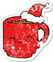 hand drawn distressed sticker cartoon of a coffee mug wearing santa hat png