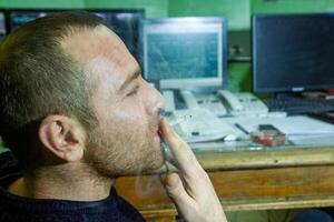 person smocking a cigarette photo