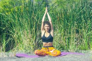 perrson doing yoga exercise on the beach, person relaxing on the beach, personn doing yoga photo