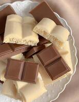 Chocolate bars on the plate, close-up, top view photo