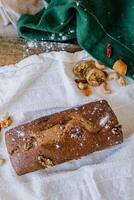 Homemade cake with nuts and raisins on a wooden background photo