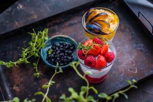 Chia seed pudding with fresh strawberries and blueberries, selective focus photo