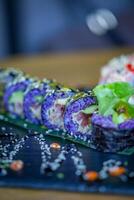 Sushi roll with salmon tuna avocado and tobiko caviar photo