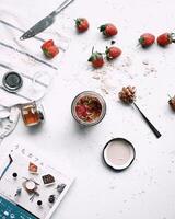 Healthy breakfast with granola and fresh berries on light background, top view photo